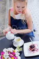 a beautiful young blond girl in summer dress at the table