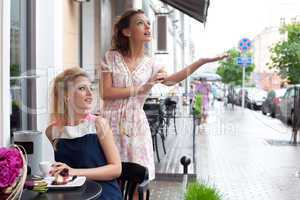 two beautiful young girls in summer outfit have lunch