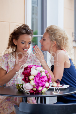 two beautiful young girls in summer outfit have lunch