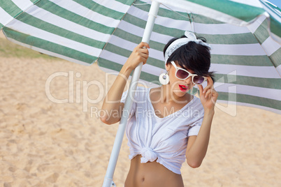 a beautiful young girl in retro look with red lips