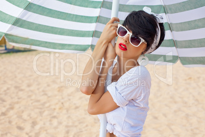 a beautiful young girl in retro look with red lips