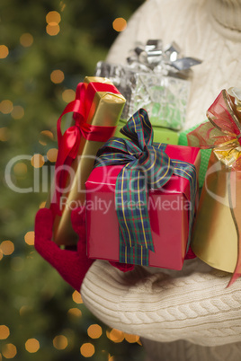 Woman Wearing Seasonal Red Mittens Holding Christmas Gifts