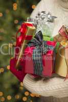 Woman Wearing Seasonal Red Mittens Holding Christmas Gifts