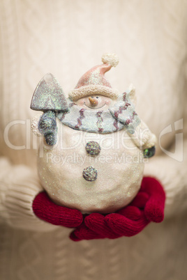 Woman Wearing Seasonal Red Mittens Holding Glass Snowman