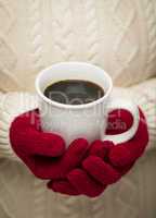 Woman in Sweater with Red Mittens Holding Cup of Coffee