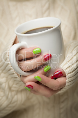 Woman with Red and Green Nail Polish Holding Cup of Coffee