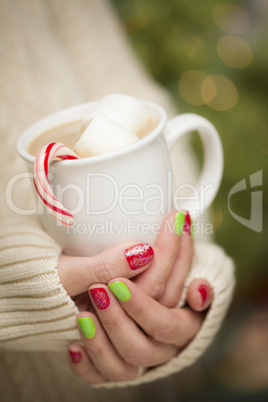 Woman with Red and Green Nail Polish Holding Cup of