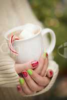 Woman with Red and Green Nail Polish Holding Cup of