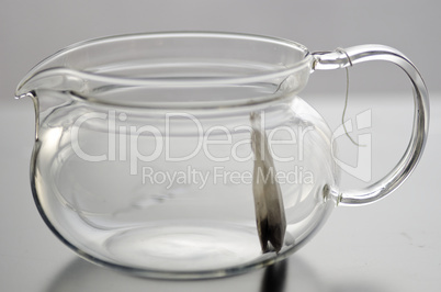Empty glass tea pot with tea bag