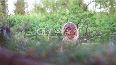 Little girl playing in the forest. Hand shoot