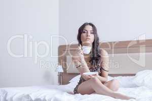 Beautiful woman drinking coffee in bedroom