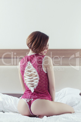 Beautiful woman sitting on bed