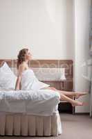 pretty young blond woman stand from bed