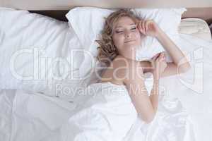 Pretty young woman sleep in white bed