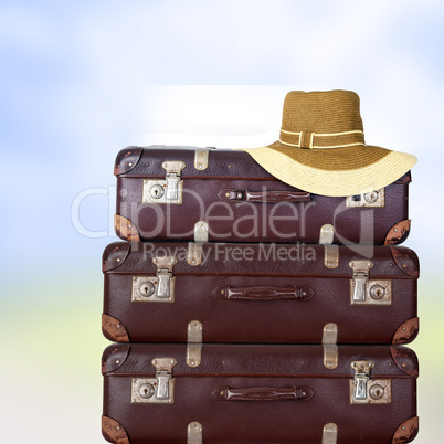 Old suitcase with women's hat