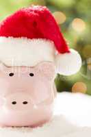 Pink Piggy Bank with Santa Hat on Snowflakes