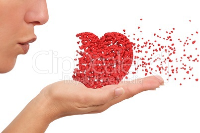 Woman blowing a heart