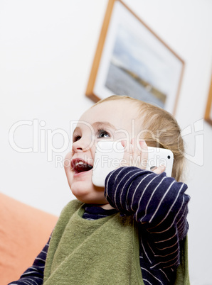 young child on couch with cell phone