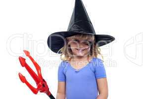 Pretty girl in witches hat holding devils pitchfork