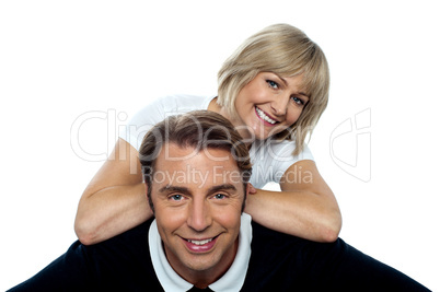 Beautiful wife leaning over her cheerful husband