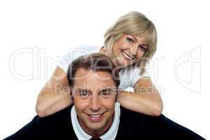 Beautiful wife leaning over her cheerful husband