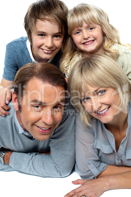 Parents lying down with children on top