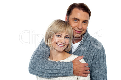 Stylish man embracing his wife from behind