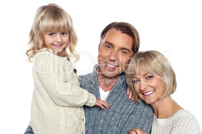 Cheerful family of three posing for camera