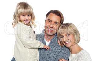 Cheerful family of three posing for camera