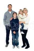 Happy family posing in trendy winter wear outfits
