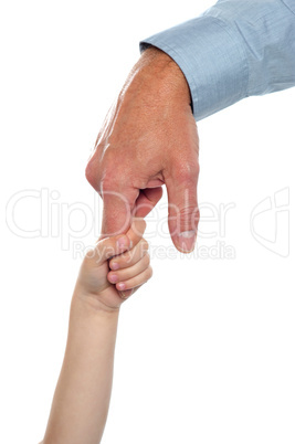 Child holding fathers finger. Family trust