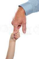 Child holding fathers finger. Family trust