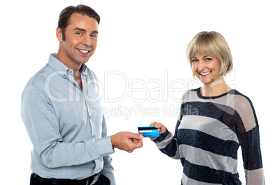 Middle aged couple showing cash card to you