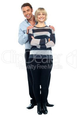 Middle aged husband holding his wife from behind