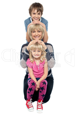 Mother posing with her adorable son and daughter