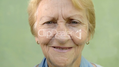 Happy old people, senior blonde woman smiling, looking at camera