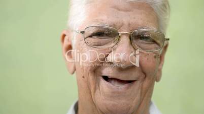 Happy old people, elderly man with eyeglasses smiling at camera