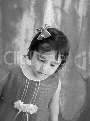 Black and white portrait of tired little girl with sad eyes.