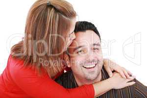 Beautiful woman kisses her husband, isolated on white