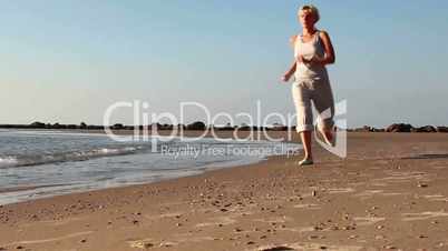 Girl jogging along a Beach    2