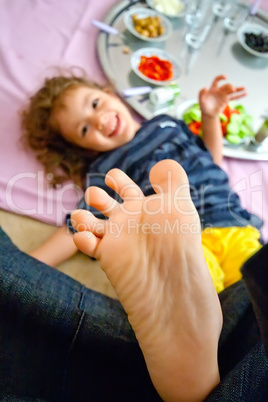 Little Girl Playing Footsie