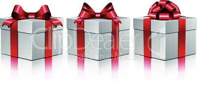 Three white gift boxes with a red bows.