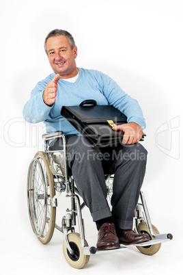 Friendly man in wheelchair holding thumbs up