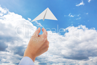 Hand throwing paper airplanes in the air