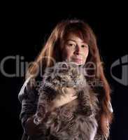 Young beautiful smiling woman holds fluffy cat
