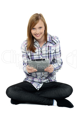 Smartly dressed teenager surfing on tablet pc