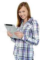 Attractive cute girl holding a tablet device