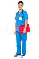 Nurse wearing blue uniform and holding red clipboard