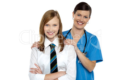 Graceful doctor posing with her teenage patient