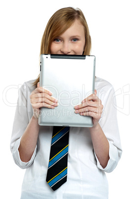 Shy girl hiding her face with a tablet device